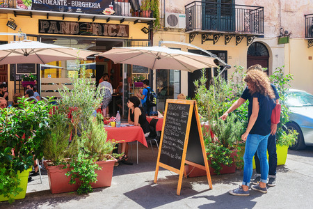 Monreale, Italy - September 18, 2017: People at the street cafe in Monreale town, Sicily, Italyのeditorial素材