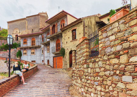 Savoca, Italy - September 27, 2017: Tourists in the cozy street of Savoca village, Sicily, Italyのeditorial素材