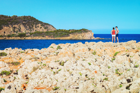 Domus de Maria, Italy - September 14, 2017: Couple at rocky Chia beach in the Mediterranian Sea, Sardinia, Italyのeditorial素材