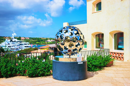 Porto Cervo; Italy - September 11, 2017: Street with metal statue at the Embankment with yachts in Porto Cervo, Sardinia, Italy.のeditorial素材