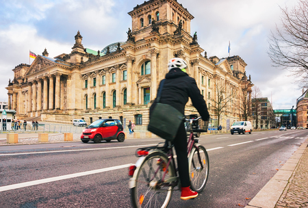 Berlin, Germany - December 8, 2017: Man on bicycle at Reichstag in Berlin, Germanyのeditorial素材