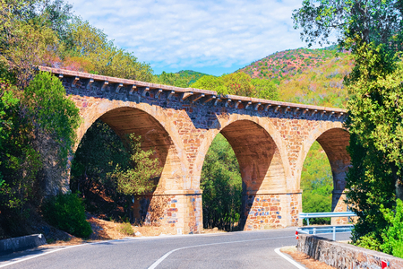 Road and aqueduct in Carbonia Iglesias province, Sardinia, Italyの写真素材