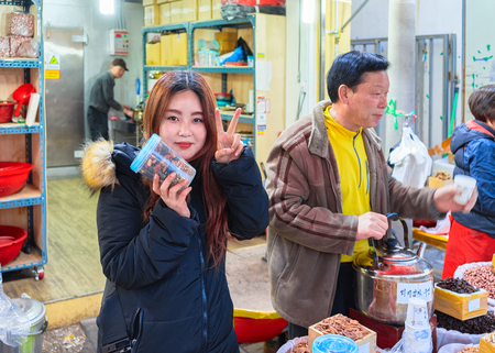 Busan, South Korea - March 12, 2016: Family selling nuts in street Fish market in Jagalchi in Busan, South Koreaのeditorial素材