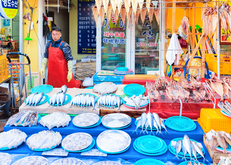 Busan, South Korea - March 12, 2016: Seller of raw fish in Fish market in Jagalchi in Busan, South Koreaのeditorial素材