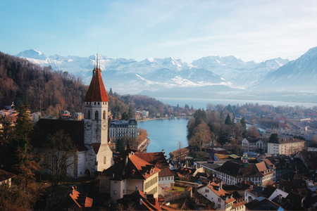 Panorama of City Church and Town of Thun with Alps and Thunersee. Thun is a city in the canton of...