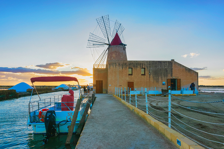 Marsala, Italy - September 19, 2017: Sunset at Windmill and the salt evoporation pond in Marsala, Sicily island in Italyのeditorial素材