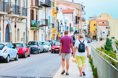 Couple at the street of Cefalu town, Palermo region, Sicily island in Italyのeditorial素材