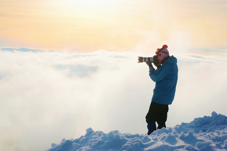 Zakopane, Poland - January 8, 2015: Man taking photos on top of Kasprowy Wierch in Zakopane at winter. Kasprowy Wierch is a mountain in Zakopane and is the most popular ski area in Polandのeditorial素材
