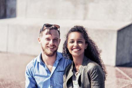 Smiling young middle eastern girl with her caucasian boyfriend happy together as diversity friendship and togetherness concept, Vilnius, Lithuaniaの写真素材
