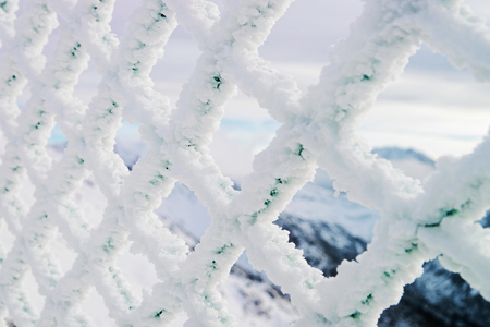 Fencing mesh being frozen and icy in mountains in winter Zakonane, Tatras, Polandの写真素材