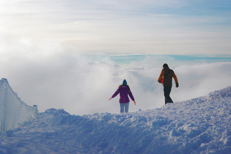 People at the top of Kasprowy Wierch of Zakopane in Tatras in winter. Zakopane is a town in Poland in Tatra Mountains. Kasprowy Wierch is a mountain in Zakopane and the most popular ski area in Polandの写真素材