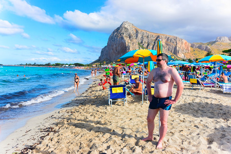 San Vito lo Capo, Italy - September 17, 2017: Man on the beach in San Vito lo Capo at the Mediterranean sea, Sicily, Italyのeditorial素材