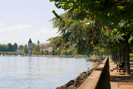 Lausanne, Switzerland - August 26, 2018: Chateau Ouchy in Geneva Lake promenade in Lausanne, Switzerland. People on the backgroundのeditorial素材