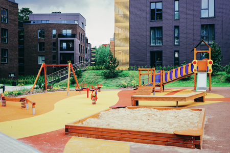 Children playground at modern complex of apartment residential buildings quarter. With outdoor facilities.の写真素材