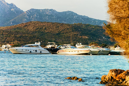Sunrise with boat at the Mediterranean sea, in Sardinia, in Italyの写真素材