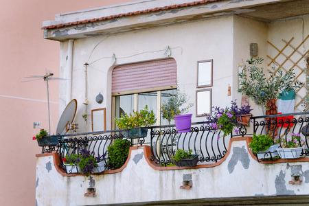 Balcony with flowers in Santa Teresa di Riva near Messina, Sicily, Italyの写真素材