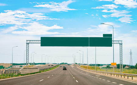 Scenery with car on the road with empty road sign indicators in Polandの写真素材