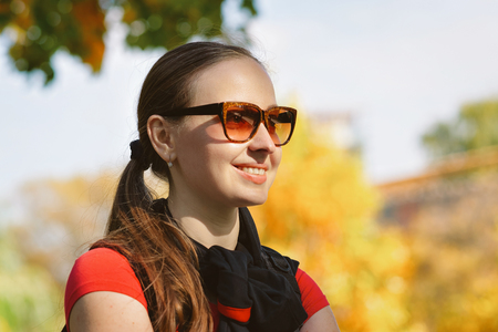 Smiling girl wearing sunglasses at Novodevichy Convent Park in Moscow in Russiaのeditorial素材