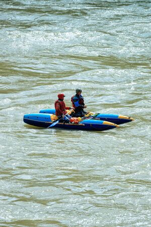 Altai, Russia - July 2, 2013: People on canoe kayaking in Katun River on Altai of Russia