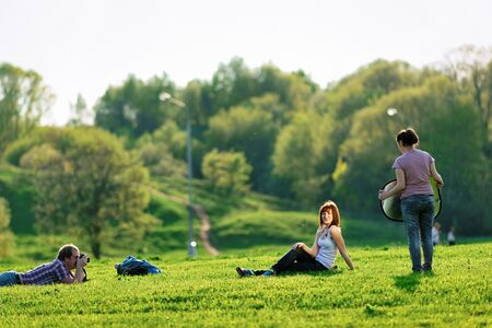 Moscow, Russia - May 8, 2010: Photographer taking photos of a young woman in Kolomenskoye park in Moscow, in Russiaのeditorial素材