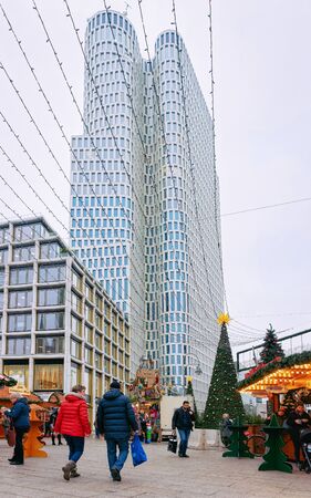 Berlin, Germany - December 11, 2017: People and Christmas Market stalls at Kaiser Wilhelm Memorial Church in Winter Berlin, Germany. Advent Fair Decoration and Stalls with Crafts Items at Bazaar.のeditorial素材