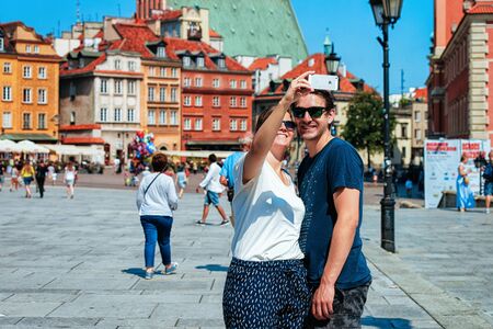 Warsaw, Poland - July 30, 2018: Young couple making selfie on Castle Square in Warsaw in Polandのeditorial素材