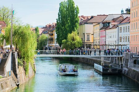 Ljubljana, Slovenia - April 27, 2018: Excursion boat in Ljubljanica River in the historical center of Ljubljana, in Sloveniaのeditorial素材