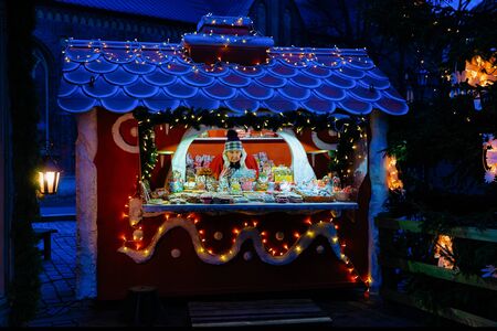 Riga, Latvia - December 28, 2017: Senior woman selling one of the most traditional sweet treats which are gingerbreads pictured at the Christmas Market in Riga, Latvia.のeditorial素材