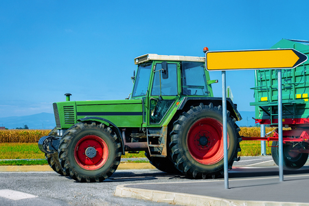 Agricultural tractor on the highway road in Poland.の写真素材