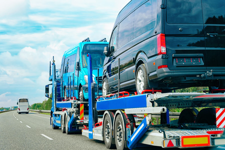 Truck carrier with mini vans on the asphalt road of Slovenia.の写真素材