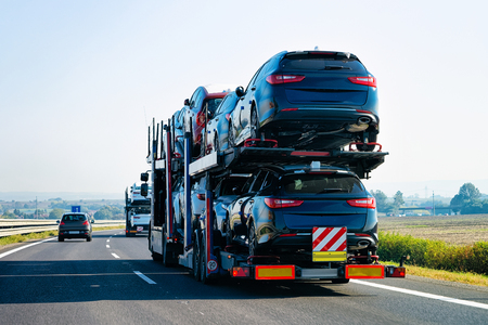 Cars carrier truck on the asphalt road, Poland. Truck transporterの写真素材