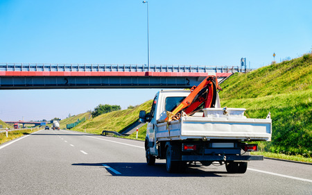 Truck carrying trailer with crane at the asphalt road in Slovenia.の写真素材