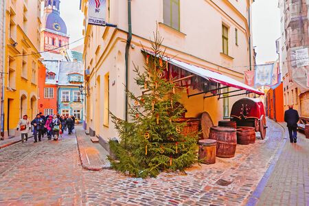 Riga, Latvia - December 27, 2014: Christmas tree in the Old Town of Riga in Latvia in winter. Dome Cathedral on the background.のeditorial素材