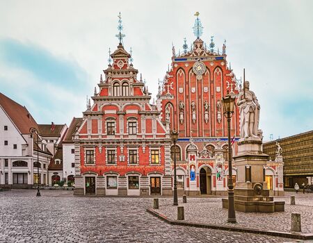 Riga, Latvia - December 25, 2015: House of Blackheads and Roland statue in the Town Hall square in Riga in Latvia in winter. At sunsetのeditorial素材