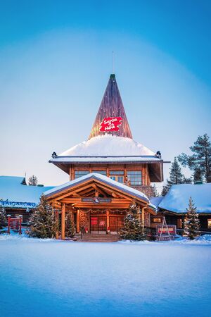 Rovaniemi, Finland - March 5, 2017: Santa Claus Office in Santa Village with Christmas trees in Finnish Lapland. Scandinavia, on Arctic Circle in winter. At duskのeditorial素材