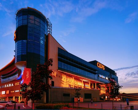 Vilnius, Lithuania - September 6, 2018: Modern shopping center building Ozas concept. Street, late at nightのeditorial素材