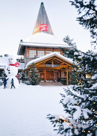 Rovaniemi, Finland - March 5, 2017: Snowman at Santa Office in Santa Claus Village in Lapland. Finland, on Arctic Circle in winter. People on the backgroundのeditorial素材
