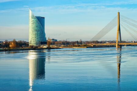 Riga, Latvia - December 27, 2017: Modern Swedbank office business skyscrapers, Vansu Bridge and Daugava River in Riga in Latvia.のeditorial素材