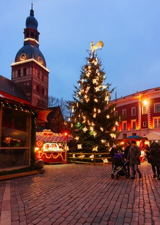 Riga, Latvia - December 27, 2017: People at Christmas tree at Riga Cathedral on the Dome square in winter Riga in Latvia.のeditorial素材