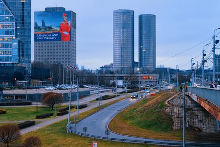 Riga, Latvia - December 27, 2017: Street view with road and modern business skyscrapers in Riga in Latvia. In the eveningのeditorial素材