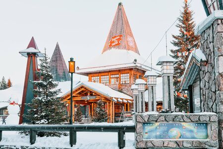 Rovaniemi, Finland - March 5, 2017: Santa Claus Office in Santa Village with Christmas trees in Lapland of Finland. Scandinavia, on Arctic Circle in winter. People on the backgroundのeditorial素材