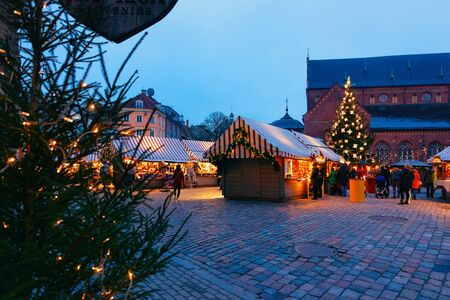Riga, Latvia - December 27, 2017: Christmas tree and night Christmas market on Dome square in winter Riga in Latvia.のeditorial素材