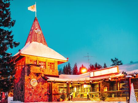 Rovaniemi, Finland - March 5, 2017: Santa Claus Main Post Office at Santa Village with Christmas trees in Lapland. Finland, Scandinavia, on Arctic Circle in winter. At nightのeditorial素材