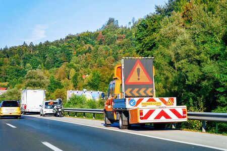 Maribor, Slovenia - September 17, 2018: Truck carrying warning road sign in highway in Slovenia.のeditorial素材