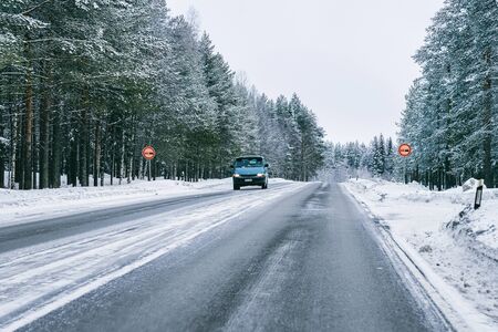 Rovaniemi, Finland - March 3, 2017: Mini van in a Snowy Winter Road of Finland in Lapland.のeditorial素材