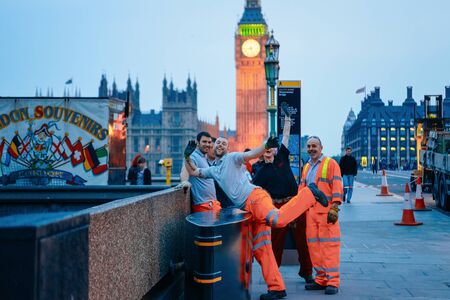London, UK - April 29, 2011: Happy Workers at Big Ben on Westminster Bridge in London old town in United Kingdom in evening. City capital of UK. England in spring. Bankside cityscape. Tired manのeditorial素材