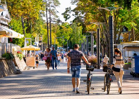 Jurmala, Latvia - September 2, 2018: Young couple on bicycles in Jurmala in Latvia.のeditorial素材