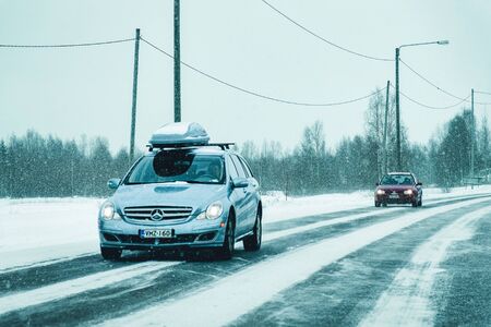 Rovaniemi, Finland - March 1, 2017: Car with roof rack at the winter snowy road at Rovaniemi in Lapland, Finlandのeditorial素材