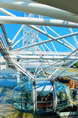 London, UK - April 30, 2011: Cable car of London Eye Ferris Wheel at Thames River in London city in the UK. Skyline with famous Icon construction and place for travel and culture.のeditorial素材