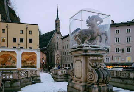 Salzburg, Austria - February 2, 2019: Horse Pond Statue in Old city in Salzburg in Austria in Europe. Mozart town in Austrian Alps in winter. Landmark with peopleのeditorial素材